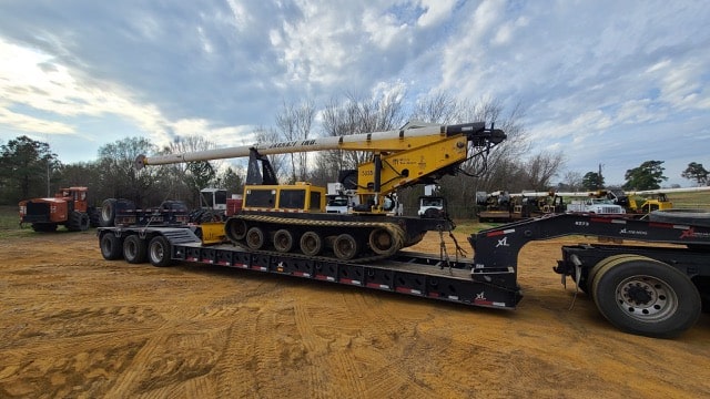 Tree trimmer on RGN trailer for transport