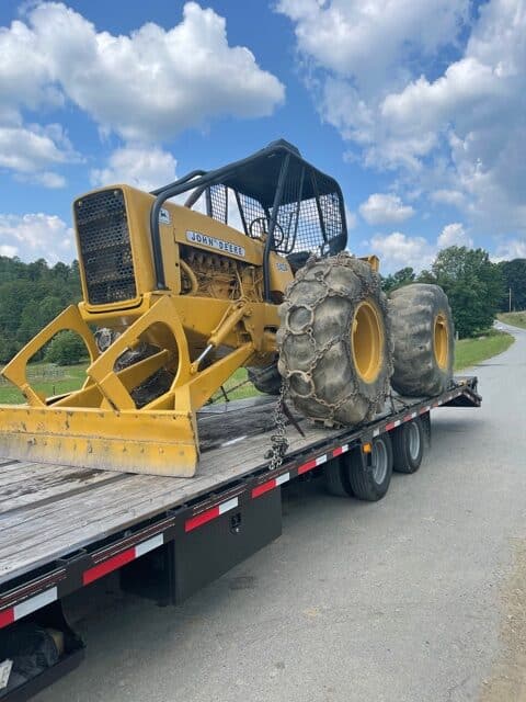 John Deere tractor on trailer for transport