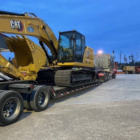 Loading a heavy equipment on a trailer