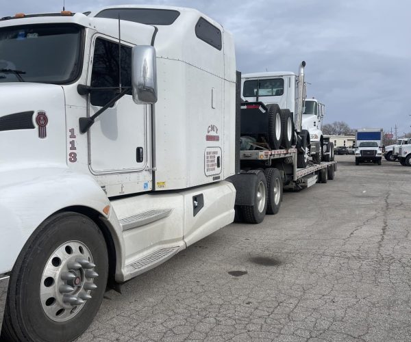 Transporting a semi truck on an rgn trailer Semi trailer loaded on an rgn trailer