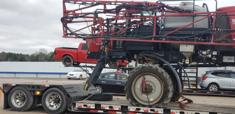 Case sprayer on trailer for transport