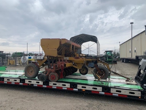 farm equipment on trailer for transport