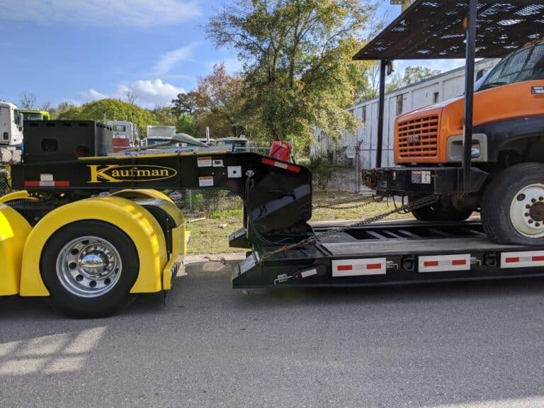 GMC bucket truck on RGN trailer