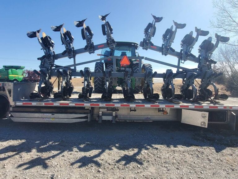 Cultivator on step deck trailer