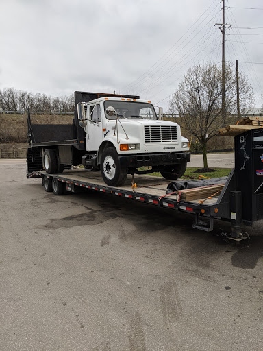 International 4700 work truck on trailer