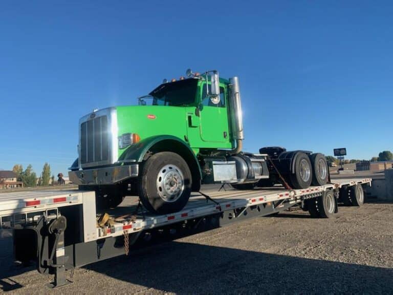 semi truck prepared for transport on a trailer
