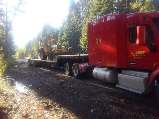 backhoe on step deck trailer for transport