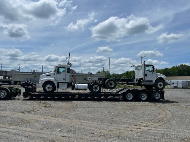 semi trucks on RGN for transport