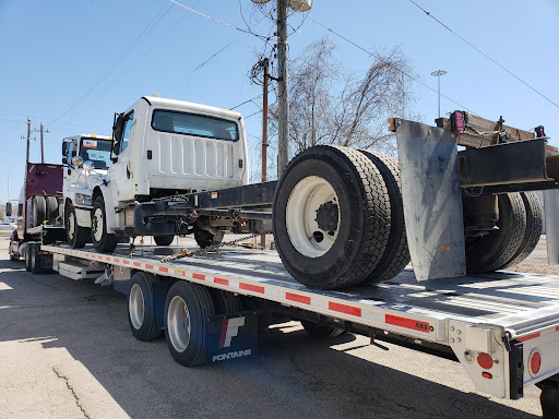 Semis on step deck trailer for transport