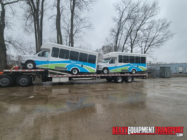 Shuttle buses transported on step deck trailer.