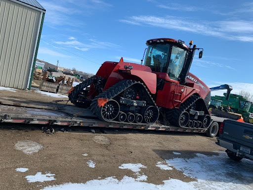 Case tractor on trailer for transport