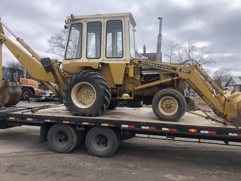 international 260A loader backhoe on a flatbed trailer