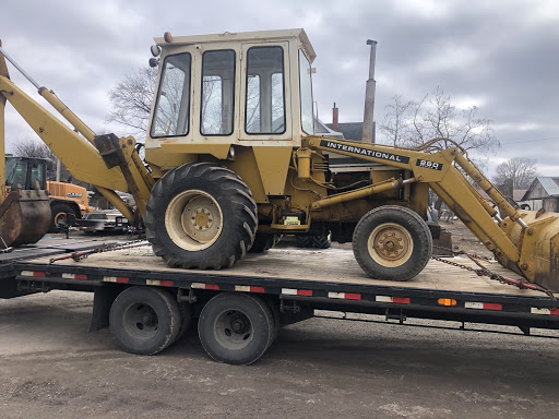 international 260A loader backhoe on a flatbed trailer