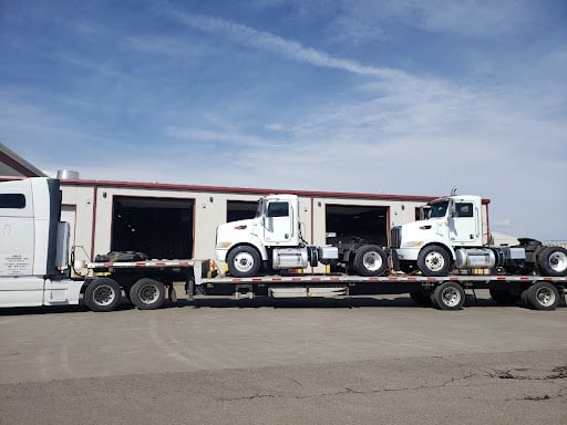 Hauling of two daycab semi trucks.