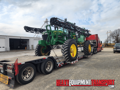 2013 John Deere 4730 Sprayer loaded on a lowboy trailer for transport