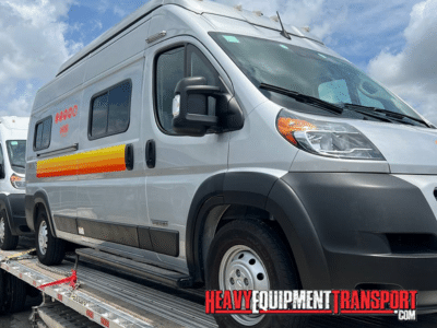 2022 Winnebago Solis 59P RV loaded for transport on a step deck trailer