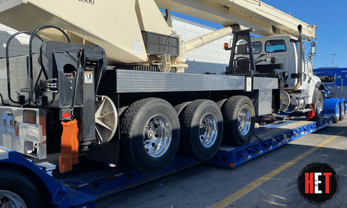 boom truck on lowboy trailer for transport