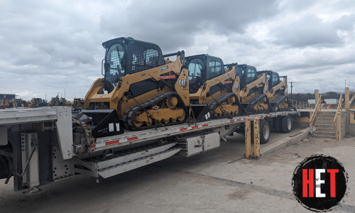 4 Cat 259 Skid Steers loaded for transport