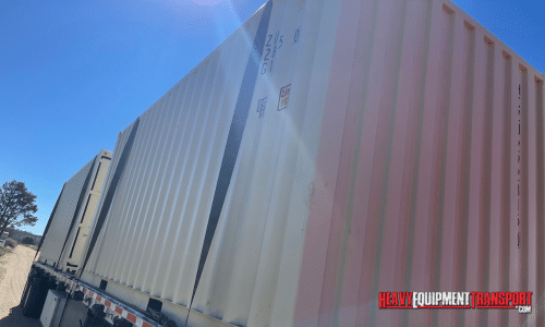 Shipping containers on a step deck trailer.