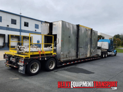 hauling a Powder Coat Paint System on a lowboy trailer