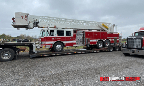 Shipping a fire truck on a lowboy trailer.