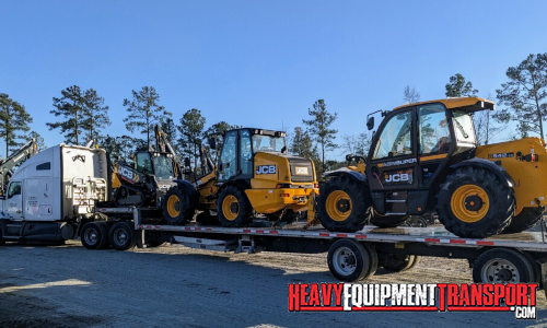 JCB Tractors transported on a flatbed trailer.