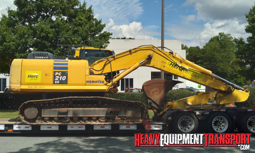 Komatsu excavator transported on a trailer.