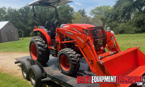Kubota tractor transported on a trailer.