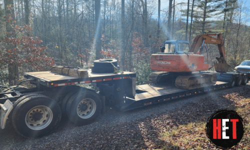Hitachi EX100-5 Excavator loaded on a lowboy trailer for transport