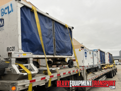 Airport baggage ready for shipping on a step deck trailer